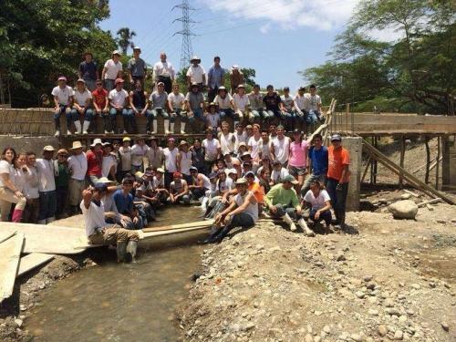 2014 BYM participants at the end of the Mission Trip stand proudly on the newly constructed bridge.